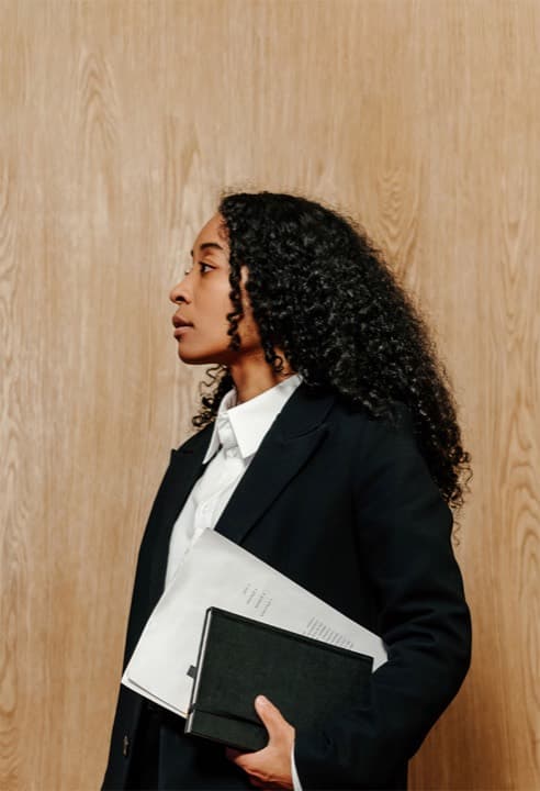 A paralegal studies student holding legal documents