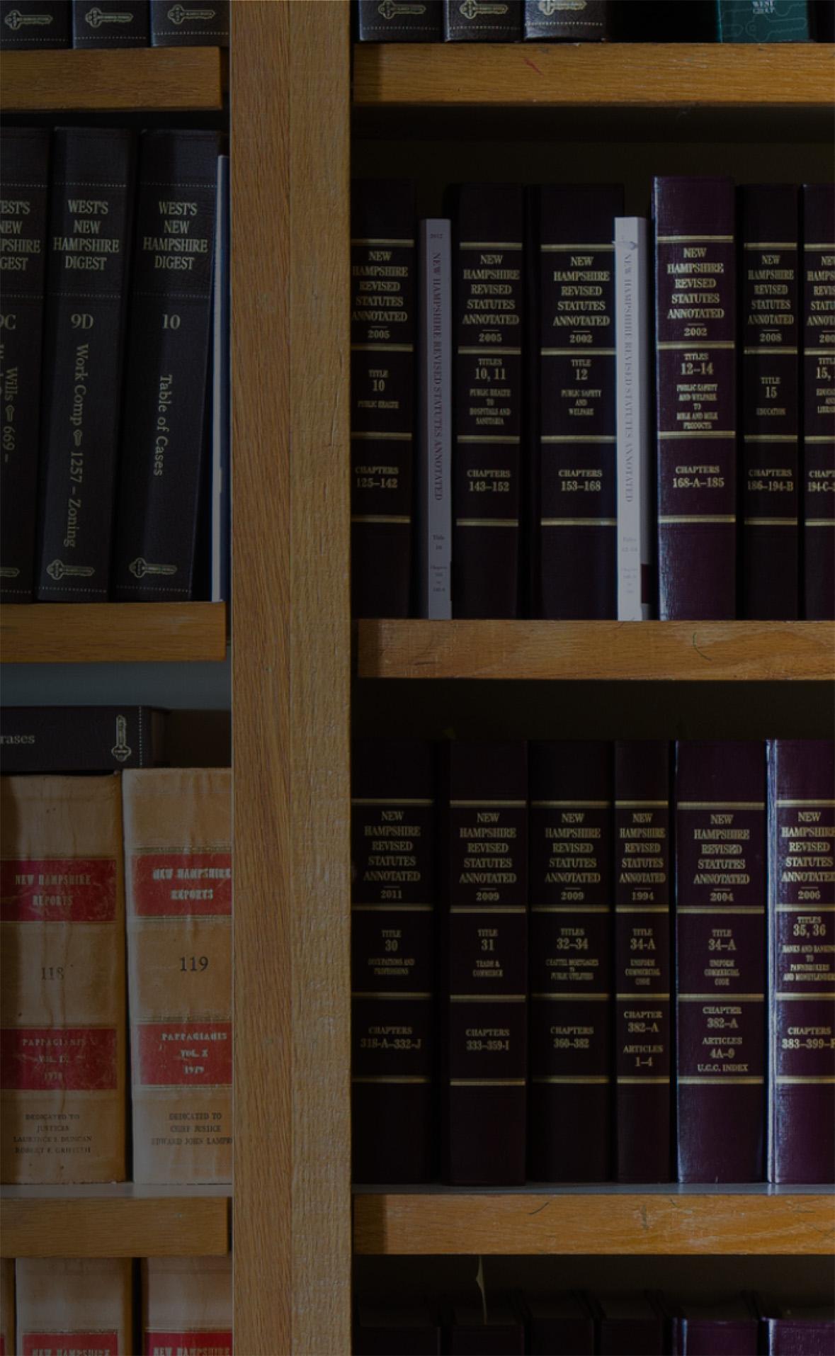 Shelf of law books in library, representing study resources for ABA-approved online AA Paralegal Studies degree.