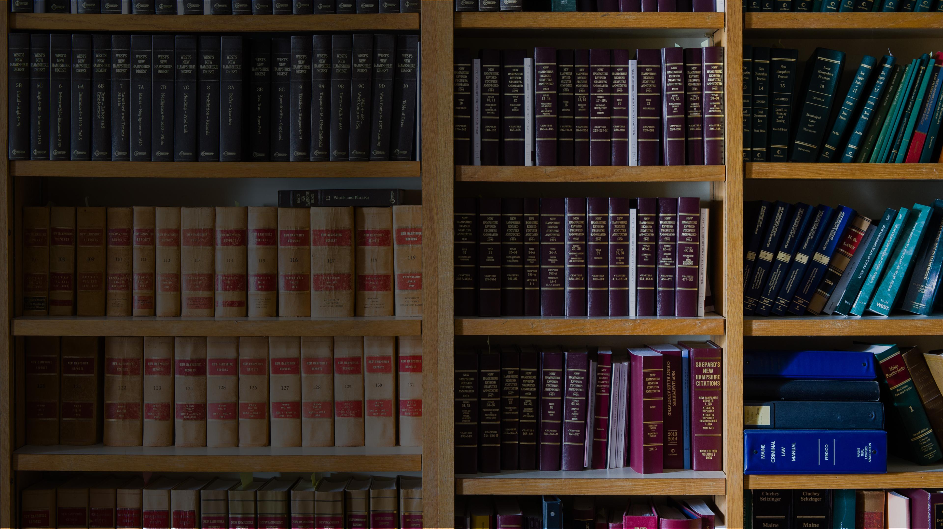 Shelf of law books in library, representing study resources for ABA-approved online AA Paralegal Studies degree.